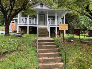 a white house with a sign in front of it at Cochran Farm House in Bryson City