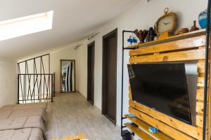 a living room with a large flat screen tv at TJ GARDENS in Makhinjauri