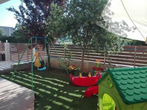 a backyard with a playground with a swing at Maria's Apartment Nafplio in Nafplio