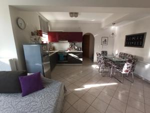a kitchen and living room with a couch and a table at Maria's Apartment Nafplio in Nafplio