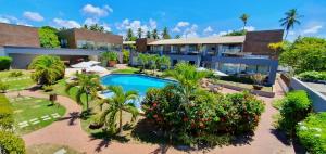 an aerial view of a house with a swimming pool at Imbassaí Apartments in Imbassai