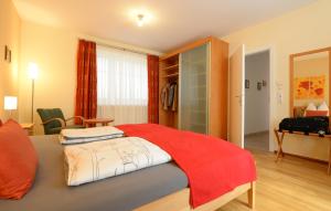 a bedroom with a bed with a red blanket on it at Ferienappartement Regina in Schrems +46 photos