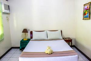 Postel nebo postele na pokoji v ubytování Remari Tourist Inn