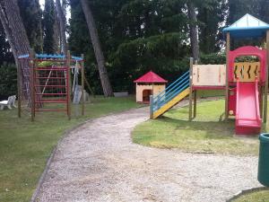 a park with several playground equipment on the grass at Residenza del Pascià - Appartamento Camphora in Oggebbio