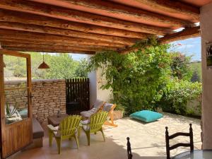 a patio with chairs and a couch and a table at Casa Can Coves in Santa Gertrudis de Fruitera