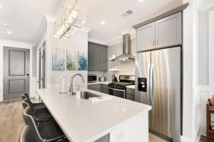 a kitchen with a white counter and a refrigerator at The Azalea Suite at 124 Spring in Charleston