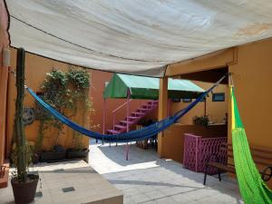 a hammock is hanging from a tent outside a building at Nova House in Mexico City