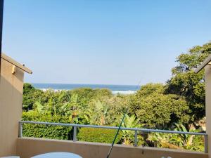 a balcony with a view of the ocean at Ocean Breeze 9 in Amanzimtoti