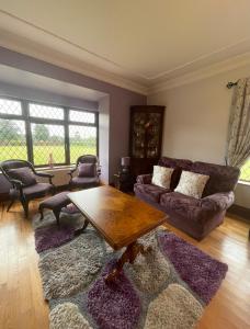 a living room filled with furniture and a window at Greenfields Country House in Latton