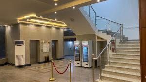 a staircase in a building with a red rope at الرؤية للشقق المخدومة - إقتصادي - Alruwyah For Serviced Apartments - Economy in Najran
