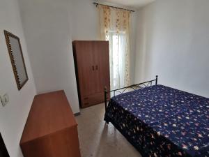 a bedroom with a bed and a table and a window at Casa Vacanze La Cantinetta Via Montesanto in Peschici