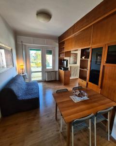 a living room with a table and a couch at Conero Apartments in Camerano