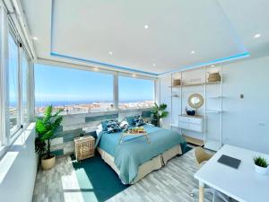 a bedroom with a large bed and a large window at Villa Blanca Tenerife - Atico Loft in San Isidro +28 photos