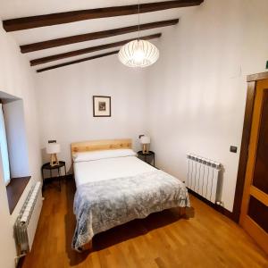 a bedroom with a large bed and two lamps at Casa Rural Iruso in Leitza