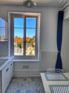 a kitchen with a large window with a view at Appartement Wimereux, plage et restaurants in Wimereux