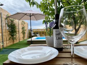 a table with a plate and a wine glass at Suite Apto de Invitados- Heated Pool-Piscina Climatizada- Montes de Málaga in Málaga