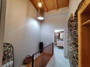 a staircase in a home with a wall of wine bottles at La Casita de la Ribeira Sacra in Monforte de Lemos