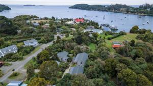 an aerial view of a house on the shore of a lake at Kaka Retreat Motel, Stewart Island in Half-moon Bay
