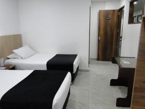 Postel nebo postele na pokoji v ubytování Hotel Esmeralda Plaza