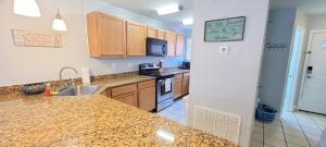 a kitchen with a sink and a counter top at Seaside Gem in Biloxi