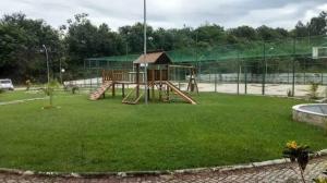 a playground with a slide in a park at Quartier das águas in Barra do Piraí
