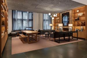 a living room with a table and a couch at Radisson Blu Hotel, London Bloomsbury in London +37 photos