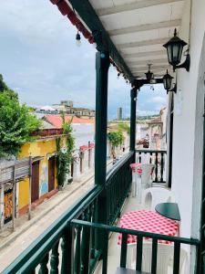 a balcony with a table and chairs and a view of the ocean at Hostal La Española de Getsemani in Cartagena de Indias