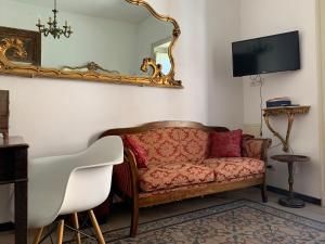 salon z kanapą i lustrem w obiekcie FraLePorte Vintage Apartment w mieście Palermo