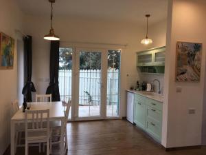 a kitchen with a table and a dining room at החן בירוק in El-Rom