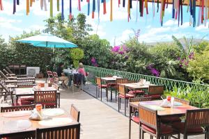 an outdoor patio with tables and chairs and umbrellas at Hotel Casa de la Tía Tere in Oaxaca City