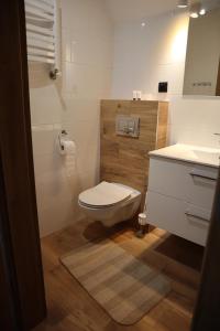 a bathroom with a white toilet and a sink at FraToLe in Nielisz