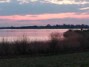 a view of a large body of water at sunset at FraToLe in Nielisz +59 photos
