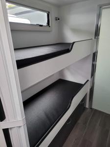 A bunk bed or bunk beds in a room at Longford Riverside Caravan Park