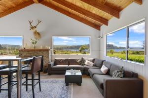 a living room with a couch and a table at Lake Brunner Lodge in Moana