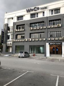 a car parked in front of a building at Woco Hotel Kinrara in Puchong