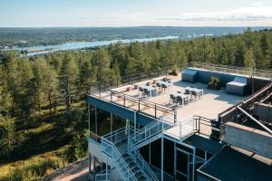 an aerial view of a house with a deck and a balcony at Lapland Hotels Sky Ounasvaara in Rovaniemi