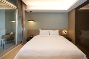 Postel nebo postele na pokoji v ubytování Hotelday Sun Moon Lake