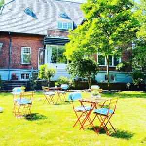 grupa stołów i krzeseł na dziedzińcu w obiekcie aday - Aalborg mansion - Studio with terrace and garden w Aalborgu