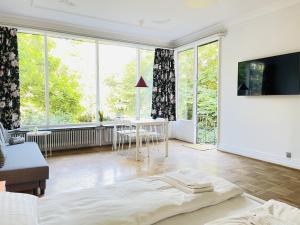 a living room with a bed and a large window at aday - Aalborg mansion - Studio with terrace and garden in Aalborg