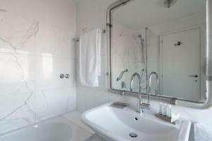 ヴェネツィアにあるPenthouse with Rooftop Terrace and 360 Views of Venice - Venice5thの洗面台と鏡のある白いバスルーム +26枚の写真
