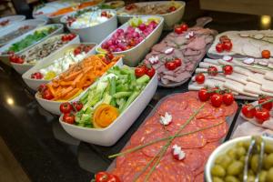 a buffet filled with different types of seafood and vegetables at SOWELL RESIDENCES Chênes Verts in Saint-Raphaël