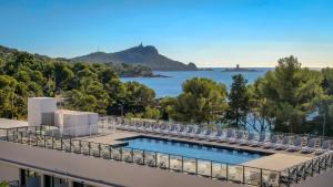 a view of the water from the balcony of a building at SOWELL RESIDENCES Chênes Verts in Saint-Raphaël