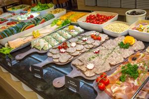 a buffet filled with different types of food on a table at SOWELL RESIDENCES Chênes Verts in Saint-Raphaël