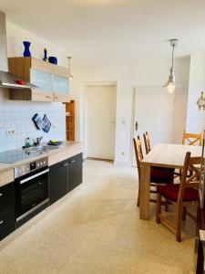 a kitchen with a table and a dining room at Ferienwohnung Heiligenhagen in Satow