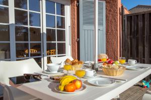 a white table with fruit on it on a balcony at SOWELL RESIDENCES Chênes Verts in Saint-Raphaël
