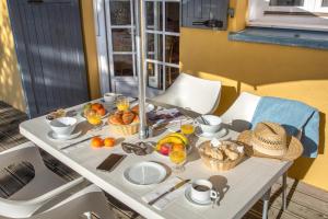 a white table with food and drinks on it at SOWELL RESIDENCES Chênes Verts in Saint-Raphaël