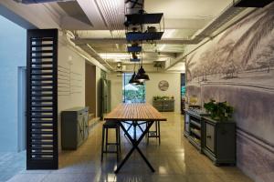 a kitchen with a wooden table in the middle of a room at Lamandau House in Jakarta
