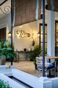 a restaurant with a table and chairs and a sign that reads yard at Lamandau House in Jakarta