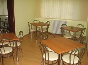 a group of tables and chairs in a room at Hotel Decebal in Braşov