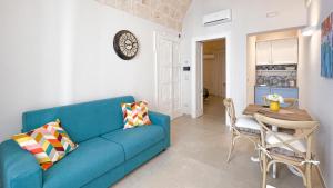 a living room with a blue couch and a table at Palazzo Palasciano in Monopoli